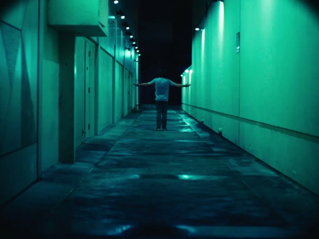 A symmetrical teal-lit alley at night